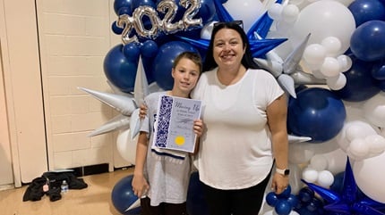Patient JoAnn Burrow pictured with her son at his elementary school graduation.
